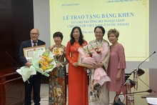Cérémonie pour décerner des certificats de mérite du ministre des AE à deux Vietnamiens à l'étranger en reconnaissance de leur contribution au développement de la ville de Dà Nang. Photo : baoquocte.vn
