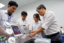 Un professeur de l'Université d'Industrie de Ho Chi Minh-Ville enseigne à des étudiants au laboratoire IoT et IA. Photo : VNA