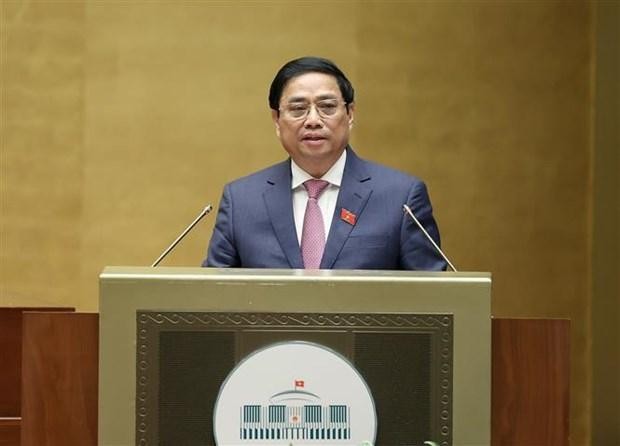 Le Premier ministre Pham Minh Chinh présente le rapport sur les résultats du développement socio-économiques pour 2022 et le plan prévu pour 2023 devant l'Assemblée nationale. Photo: VNA