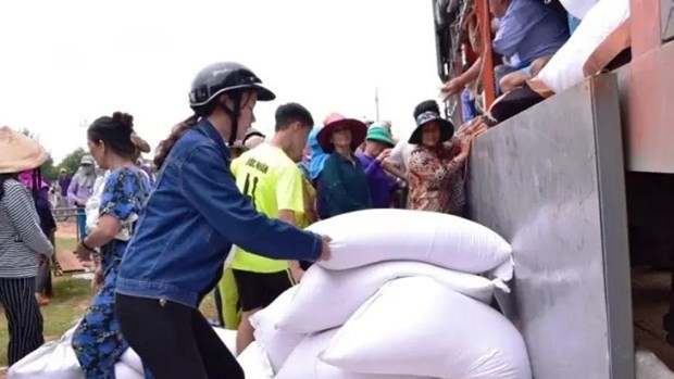 Les gens reçoivent du riz alloué par l'État. Photo : thanhnien.vn
