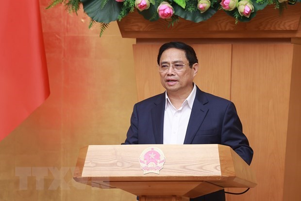 Le Premier ministre Pham Minh Chinh préside une conférence en ligne entre le gouvernement et les localités et la réunion périodique de mars du gouvernement. Photo : VNA.