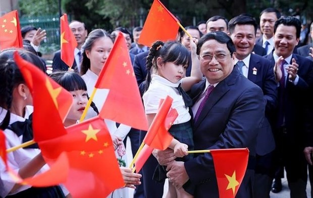 Le Premier ministre Pham Minh Chinh rencontre la communauté vietnamienne en Chine. Photo : VNA.
