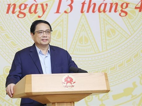 Le Premier ministre Pham Minh Chinh lors de la conférence, à Hanoi, le 13 avril. Photo : VNA