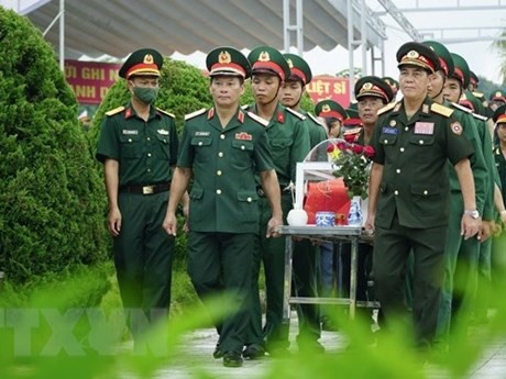 La cérémonie d'inhumation de six restes de soldats volontaires vietnamiens morts au Laos au cimetière des Morts de Tong Khao (commune de Thanh Nua, district de Diên Biên, province éponyme). Photo : VNA.