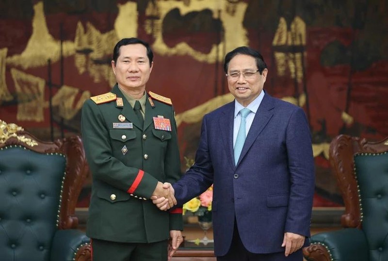 Le Premier ministre Pham Minh Chinh serre la main du général de division Saichay Kommasith, vice-ministre de la Défense et chef d’état-major général de l’Armée populaire lao, à Hanoi, le 5 mars. Photo: VNA 