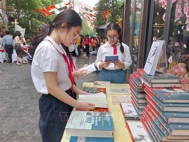 Des élèves découvrent des livres dans la Rue du livre à Hanoï. Photo : VNA 