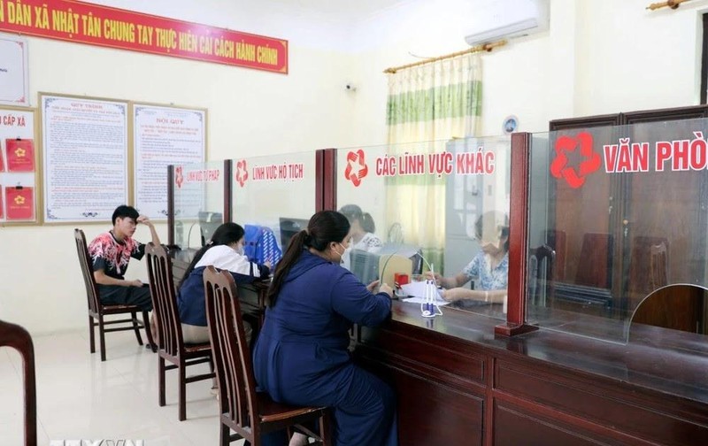 Des gens effectuent des démarches administratives au service "guichet unique" de la commune de Nhat Tan, district de Kim Bang, province de Ha Nam. Photo : VNA. 