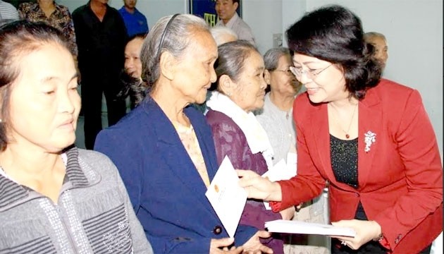 La Vice-Présidente du Vietnam, Dang Thi Ngoc Thinh (1er, à droite) offre des cadeaux aux familles méritantes à Vinh Long. Photo: NDEL.