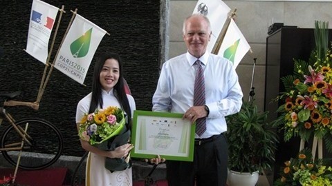 Franz Jessen remet, le 26 juin 2015, le prix à une Vietnamienne lauréate du concours de connaissance sur les changements climatiques, lancé par la Délégation de l’UE au Vietnam. Photo: CVN.