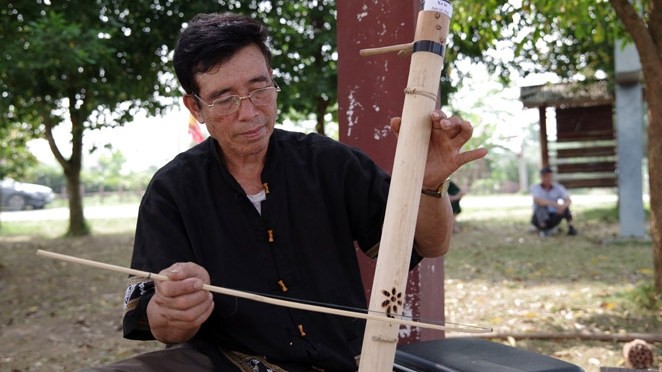 L’artiste Luong Van Nghiêp, joue à l’instrument musical de son ethnie Thai. Photo: daibieunhandan.vn.