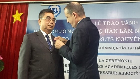 Le consul général de France à Hô Chi Minh-Ville, Vincent Floreani (à droite), remet l'Ordre des palmes académiques au professeur agrégé-docteur Nguyên Ngoc Diên. Photo: SGGP.