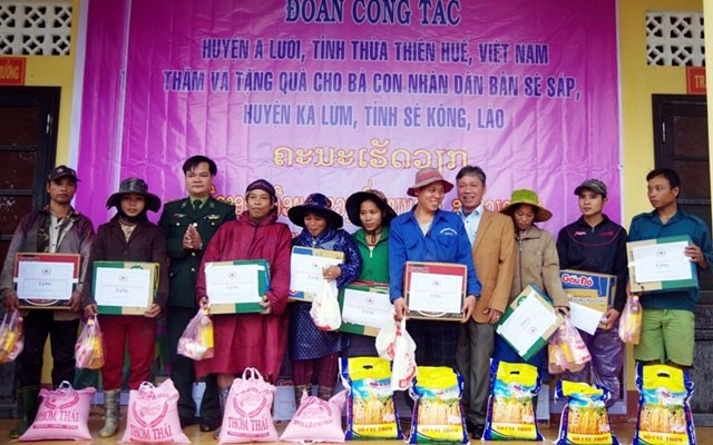La secrétaire du Comité du PCV du district d’A Luoi, Nguyên Thi Suu offre des cadeaux, d’une valeur totale de près de 30 millions de dôngs aux habitants du village de Xe Sap, district de Kaleum, province laotienne de Sekong. Photo: NDEL