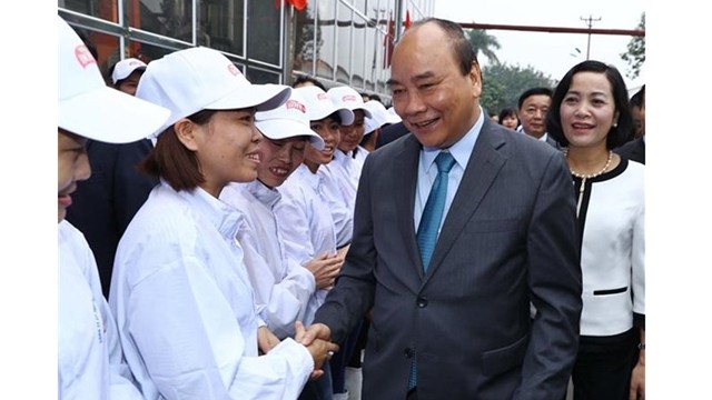 Le Premier ministre Nguyên Xuân Phuc et des employés de la société DOVECO. Photo : VNA