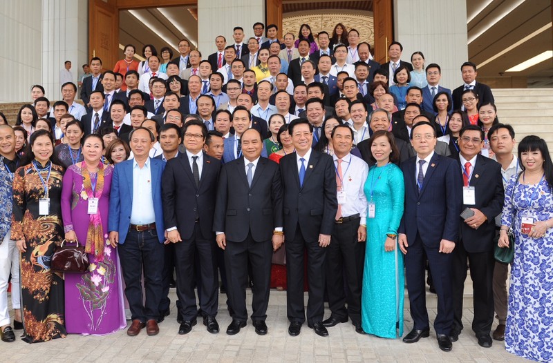 Le PM Nguyen Xuan Phuc prend la photo souvenir avec des délégués du milieu d’entreprises privées. Photo: Tran Hai/NDEL.