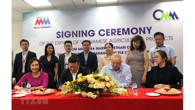 Signature du mémorandum de coopération entre la Sarl MM Mega Market Vietnam et la compagnie singapourienne CMM Marketing Management PTE LTD Singapore. Photo : VNA.