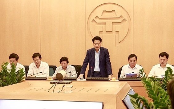 Le président du Comité populaire de Hanoï Nguyên Duc Chung (debout) lors de la réunion. Photo : NDEL.