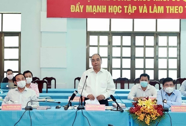 Le Président Nguyên Xuân Phuc lors de la réunion sur la situation socioéconomique, culturelle, de défense et de sécurité des districts de Cu Chi et Hoc Mon. Photo : VNA.