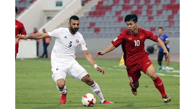Le joueur Nguyên Công Phuong (en rouge) lors d'un affrontement avec l'équipe jordanienne. Photo : VFF.