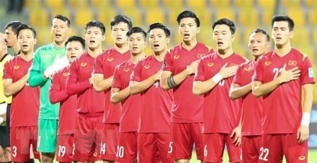 L'équipe vietnamienne salue le drapeau national avant un match. Photo : VNA.