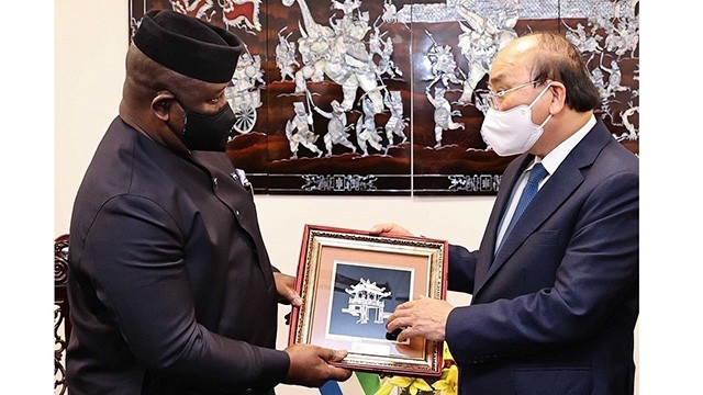 Le Président Nguyên Xuân Phuc (à droite) offre un cadeau de souvenir au Président de la Sierra Leone, Julius Maada Bio, lors d'une rencontre en marge de la discussion de haut niveau de la 76e Assemblée générale de l’ONU. Photo : VNA.